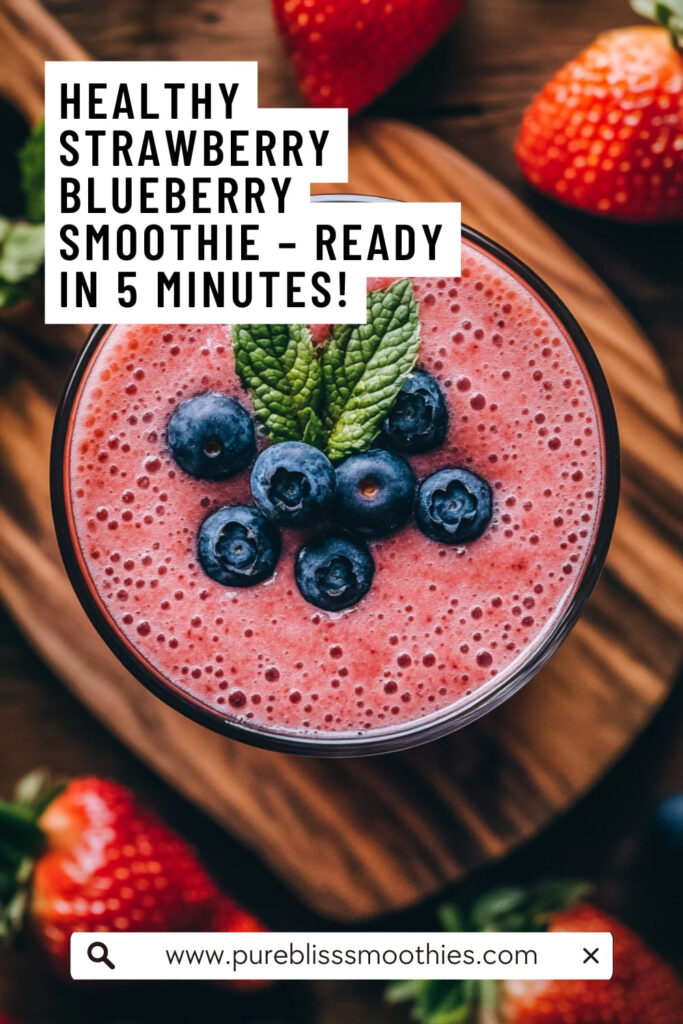 Overhead view of a healthy strawberry blueberry smoothie topped with fresh blueberries and mint, with strawberries in the background.