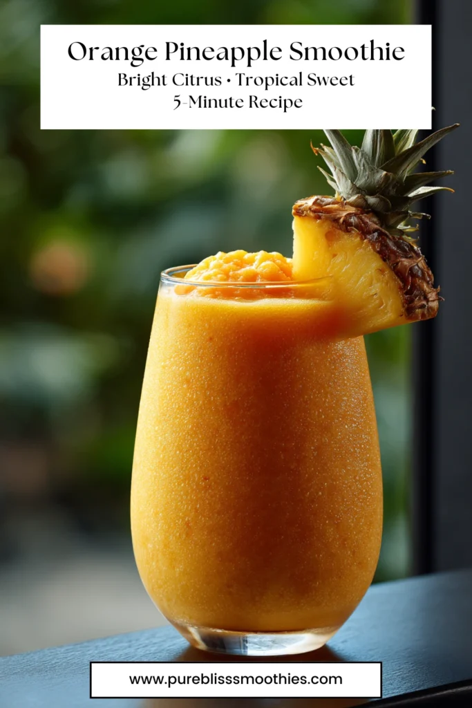 Orange pineapple smoothie in a tall glass with pineapple garnish, bright citrus tropical drink, 5-minute recipe from Pure Bliss Smoothies.