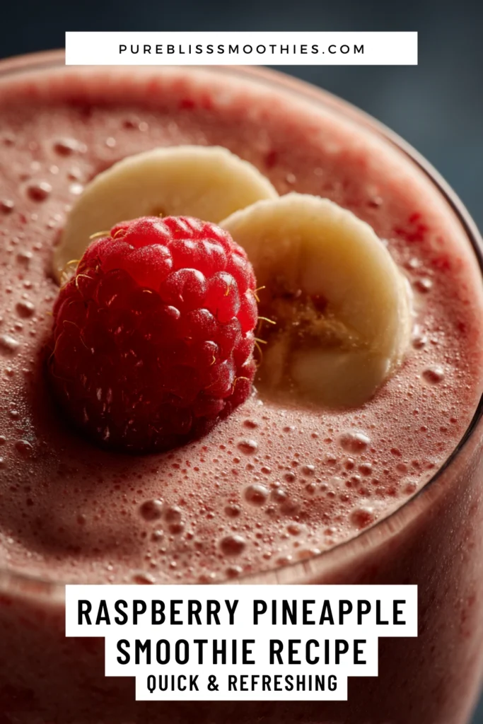 Close-up of a raspberry pineapple smoothie topped with fresh raspberry and banana slices, highlighting a quick and refreshing tropical blend.