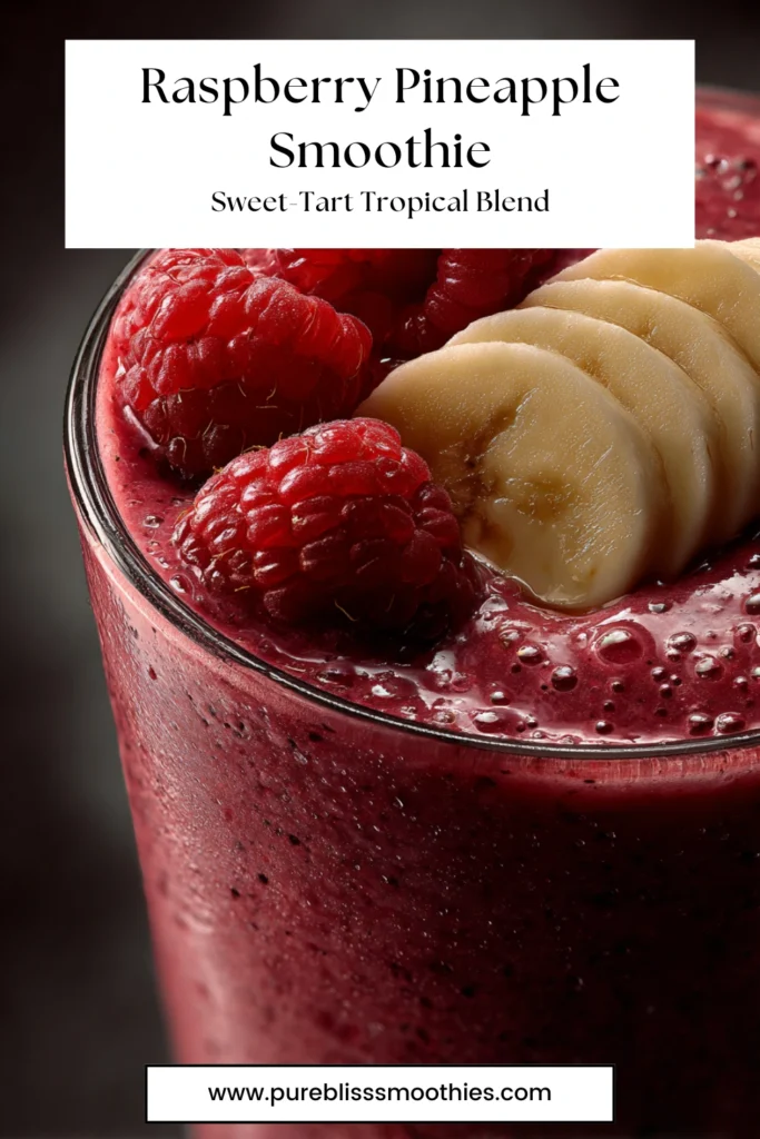 Glass of vibrant raspberry pineapple smoothie topped with fresh raspberries and banana slices, a sweet-tart tropical blend from Pure Bliss Smoothies.